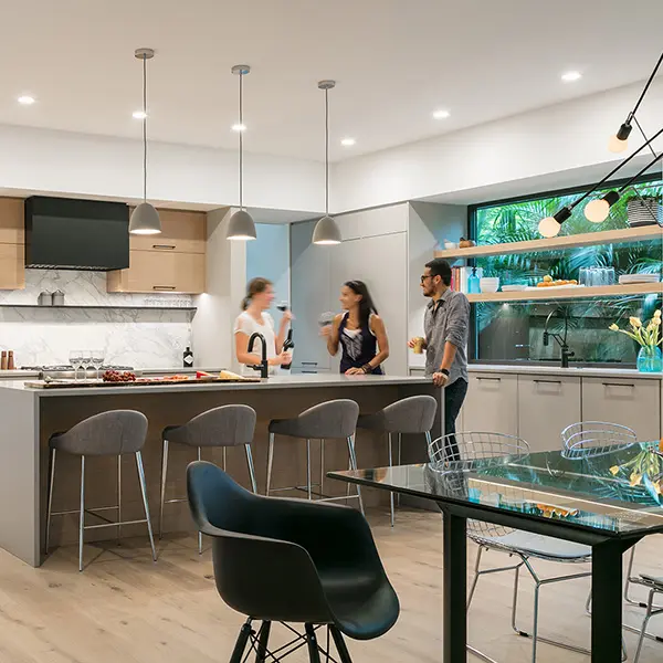 Contemporary home staging in Sarasota Florida featuring modern kitchen with island seating, pendant lighting, and open dining area