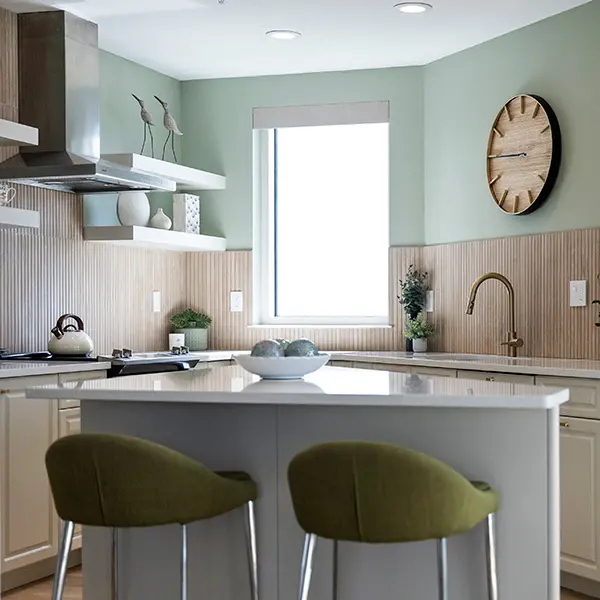 Coastal contemporary condo staging in Downtown Sarasota featuring modern kitchen with soft green tones and clean design