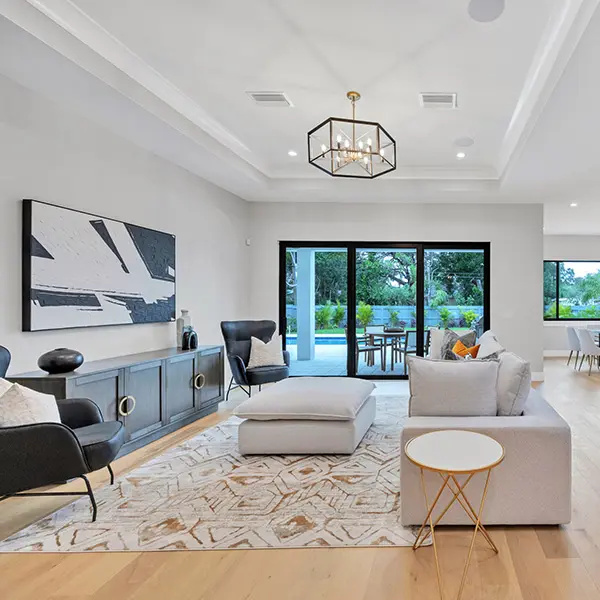Coastal contemporary home staging in East of Trail Sarasota featuring modern living room with neutral tones and open layout