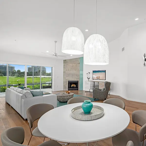 Coastal contemporary home staging in Bay Isles Longboat Key featuring open living room with golf course views and natural light