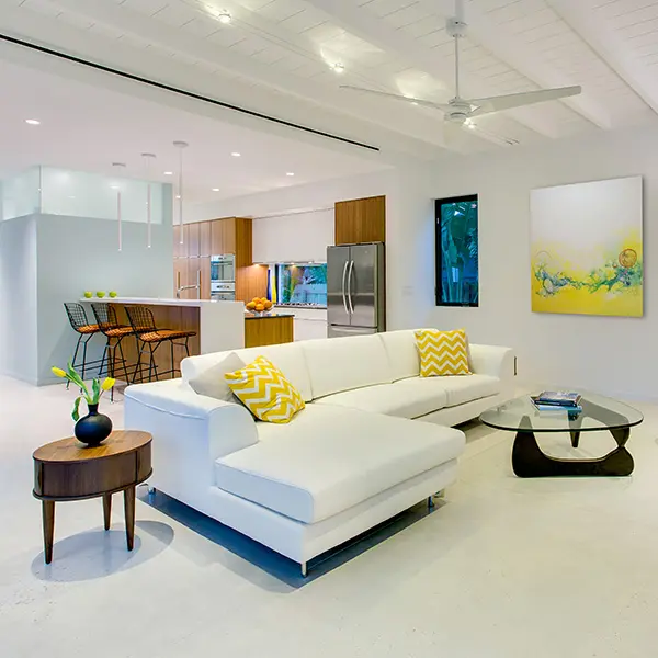 Contemporary spec home staging in Hudson Bayou Sarasota featuring open living room and modern kitchen with bright interior design