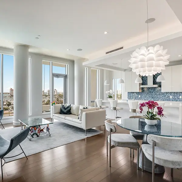 Luxury condo staging in Downtown Sarasota featuring modern open living space with floor-to-ceiling windows and city views