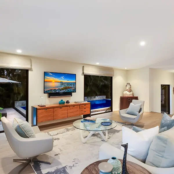 Mid-century home staging in West of Trail Sarasota featuring modern living room with clean lines and warm wood furnishings