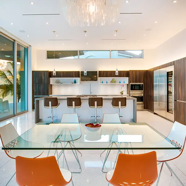 Modern luxury home staging in Sarasota featuring open kitchen and dining area with contemporary design and clean lines