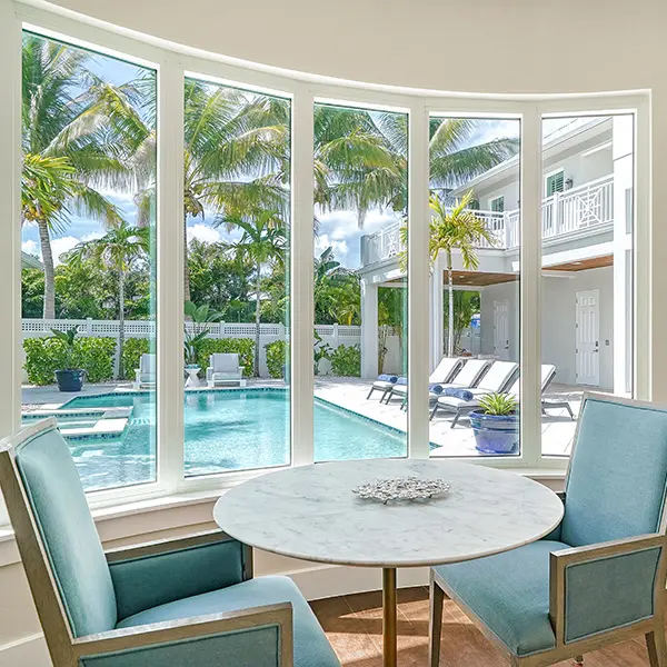 Luxury home staging in Sarasota featuring pool view through large windows and bright coastal interior