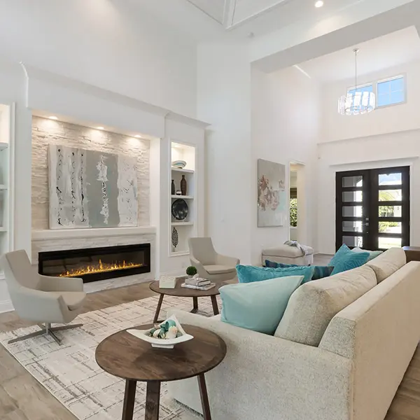 Coastal contemporary home staging in West of Trail Sarasota featuring bright living room with high ceilings and neutral tones