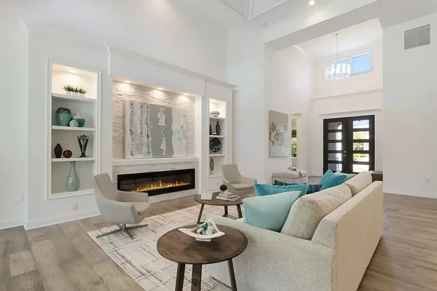 Coastal contemporary home staging in West of Trail Sarasota featuring bright living room with high ceilings and neutral tones