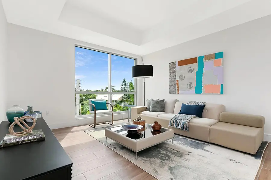 Waterfront condo staging in Siesta Key Sarasota featuring modern living room with coastal tones and balcony view