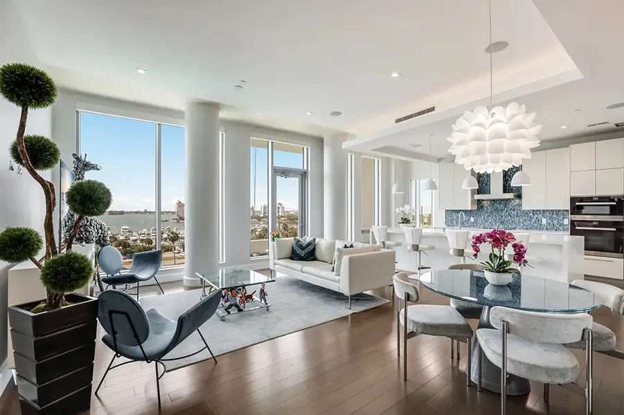 Luxury condo staging in Downtown Sarasota featuring modern open living space with floor-to-ceiling windows and city views