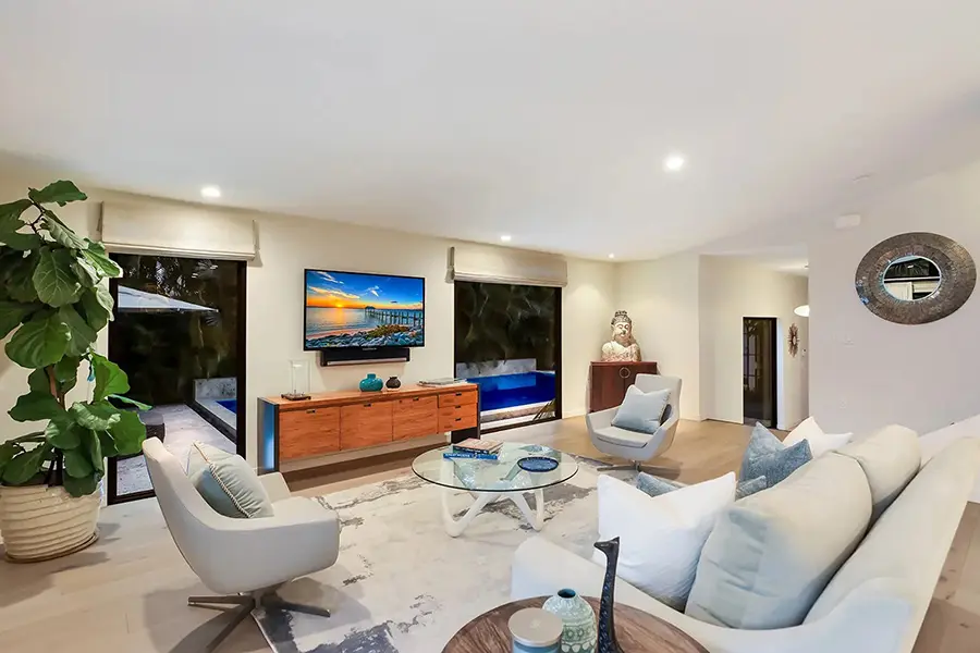 Mid-century home staging in West of Trail Sarasota featuring modern living room with clean lines and warm wood furnishings