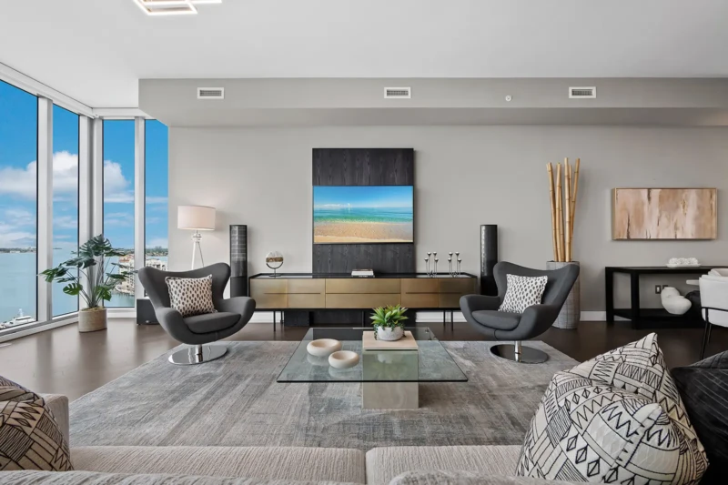 Luxury condo living room staging at The VUE Sarasota with modern furniture and panoramic bay views
