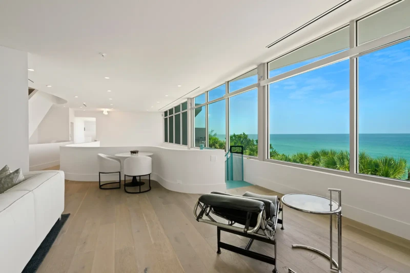 Upper level contemporary lounge staging with panoramic Gulf views on Casey Key