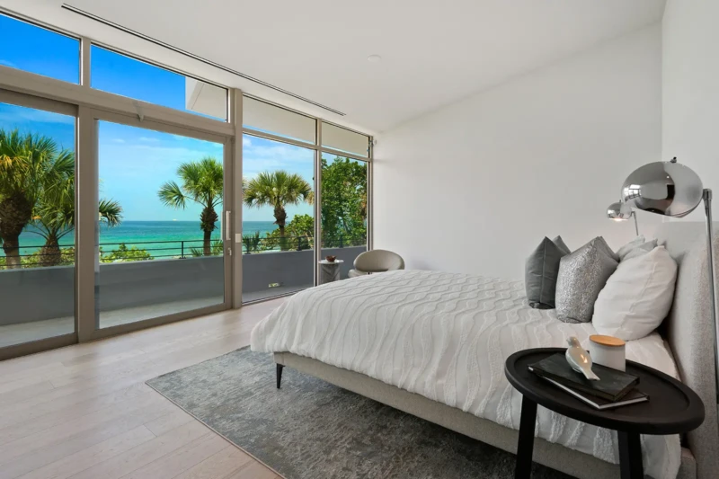 Contemporary waterfront bedroom staging with Gulf views on Casey Key