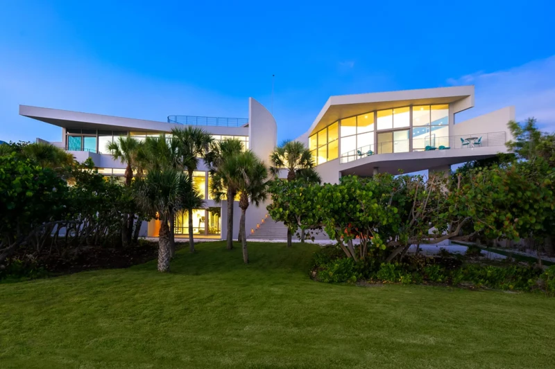 Contemporary waterfront home exterior staged on Casey Key at dusk