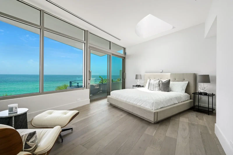 Contemporary waterfront primary bedroom staging with Gulf views on Casey Key