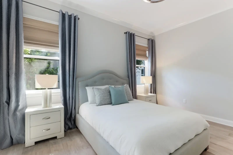 Guest bedroom staging with soft coastal tones in West of Trail Sarasota luxury home