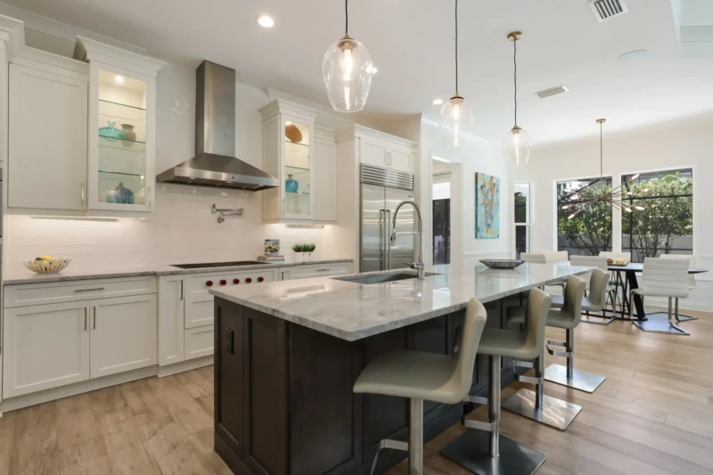 Coastal contemporary kitchen staging with oversized island in West of Trail Sarasota luxury home
