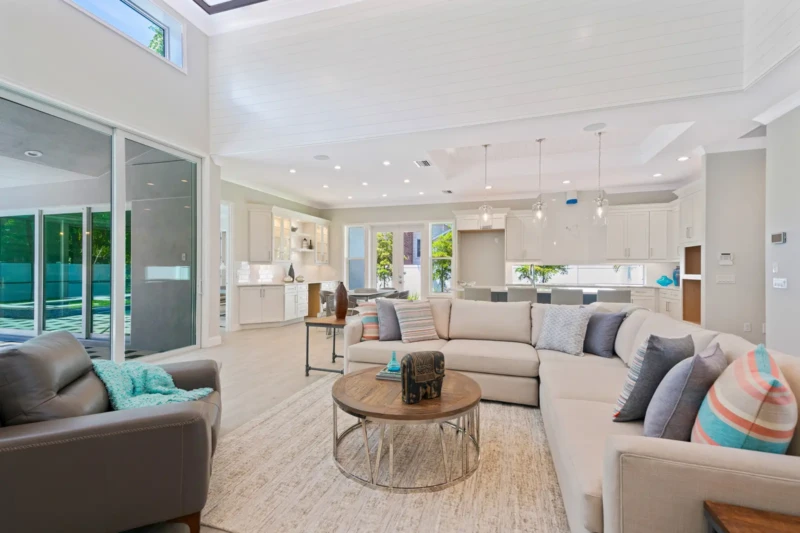 Open-concept coastal contemporary home staging with living room and kitchen in Sarasota spec home