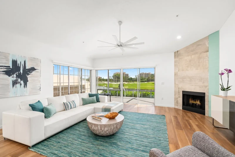 Coastal contemporary living room staging with golf course views on Longboat Key