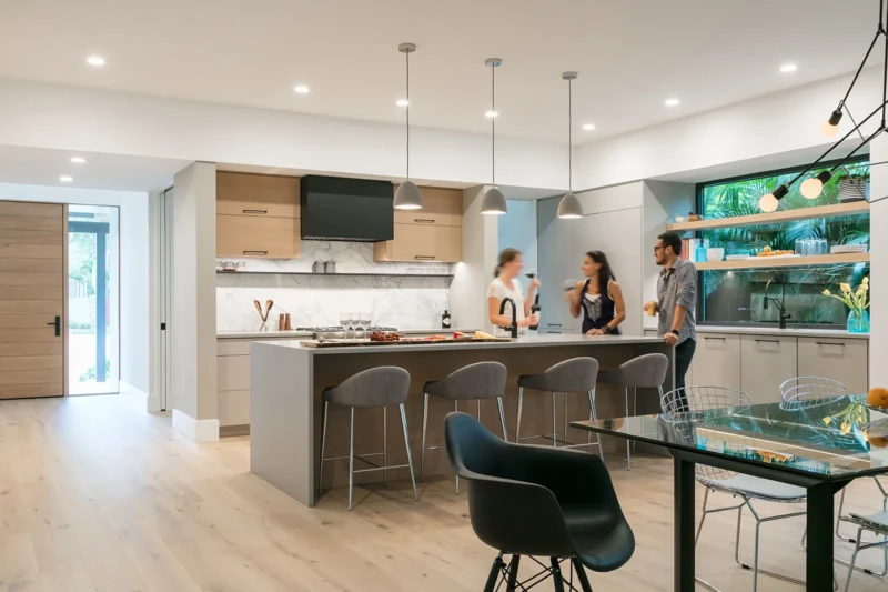 Contemporary Sarasota kitchen home staging with oversized waterfall island, modern lighting, and open-concept luxury interior design