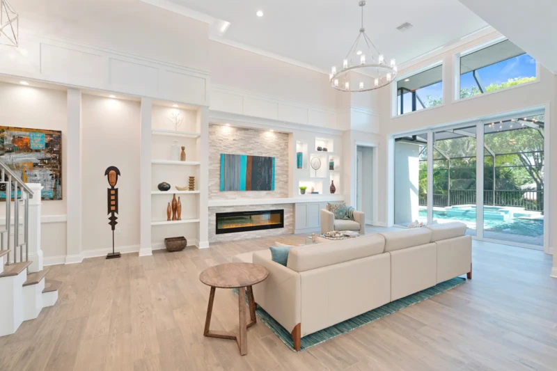 Contemporary great room staging with pool views in Paradise Shores West of Trail Sarasota home
