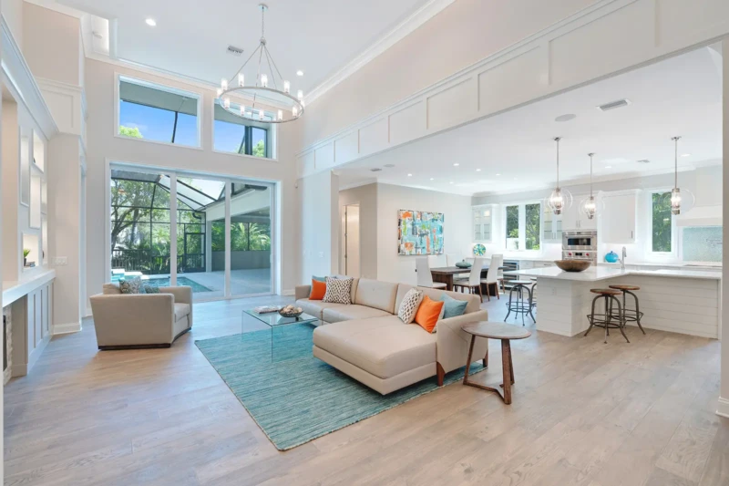 Contemporary open-concept living room and kitchen staging in Paradise Shores West of Trail Sarasota home