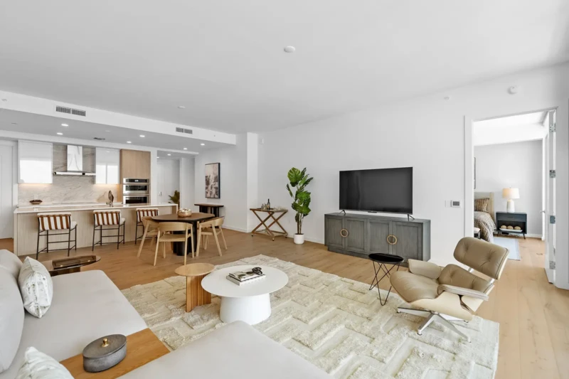 Light-filled modern condo staging with open living room, dining area, and kitchen