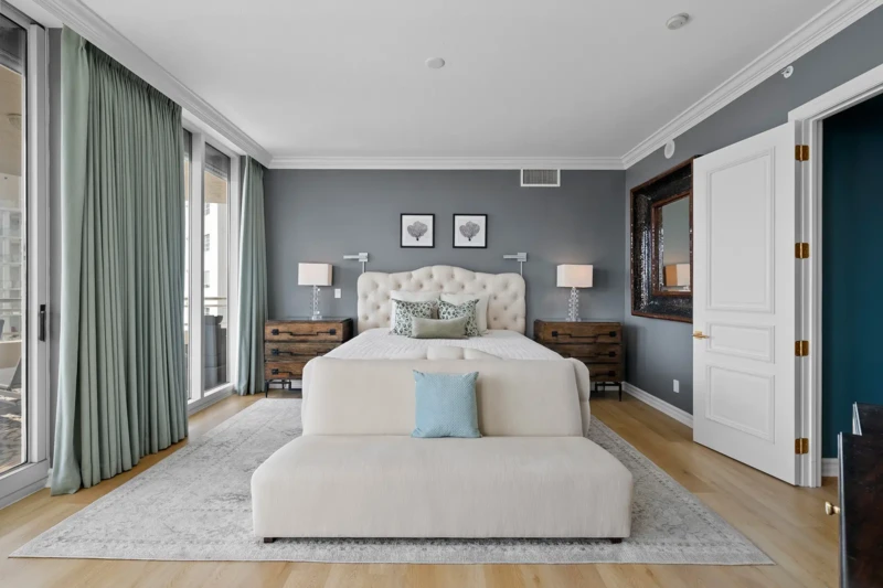 Luxury bedroom home staging with upholstered bed, soft coastal palette, and elegant contemporary furnishings in Sarasota condo interior