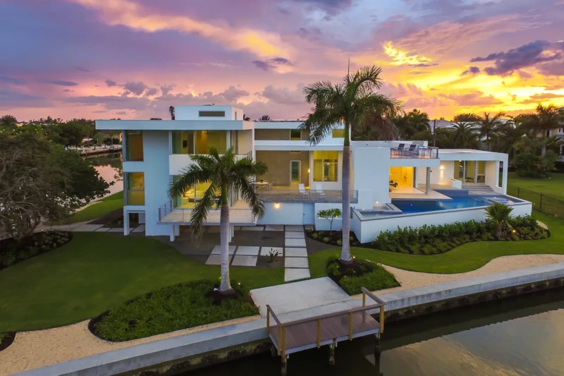 Luxury modern waterfront home on Longboat Key at sunset with elevated pool and contemporary architecture