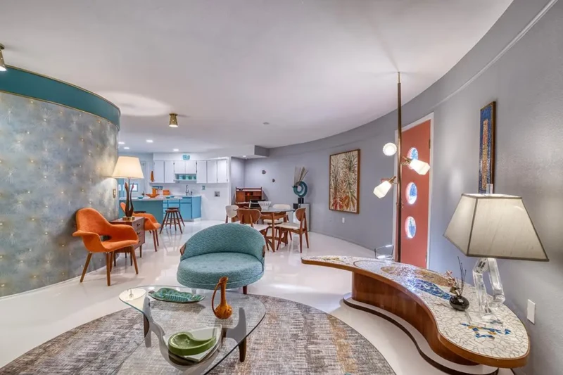 Mid-century modern Round House living room staging with curved walls and retro furnishings