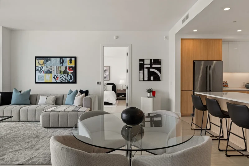 Modern condo living and dining room staging with contemporary furnishings, open-concept layout, and luxury kitchen in Sarasota