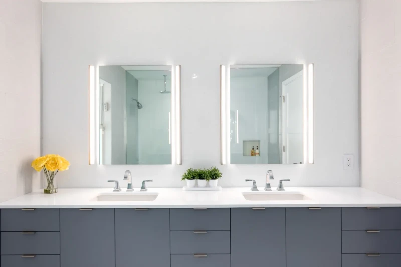 Modern bathroom staging in Bird Key Sarasota with double vanity, illuminated mirrors, and minimalist contemporary design