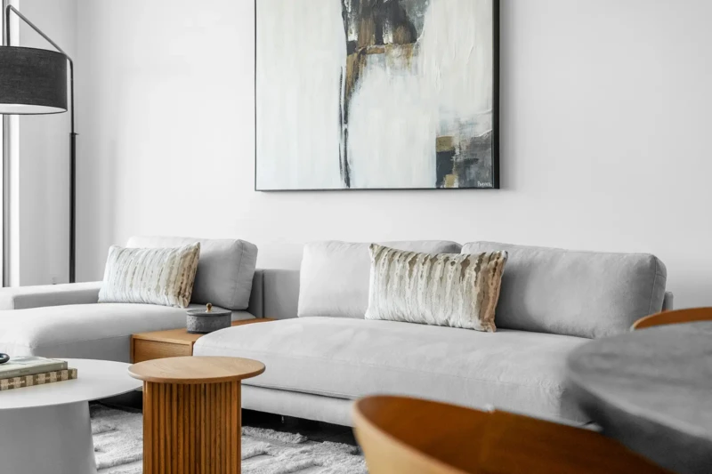 Modern living room staging with neutral sofa and abstract artwork