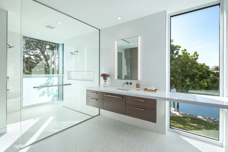 Modern luxury bathroom with glass walk-in shower and waterfront views on Longboat Key