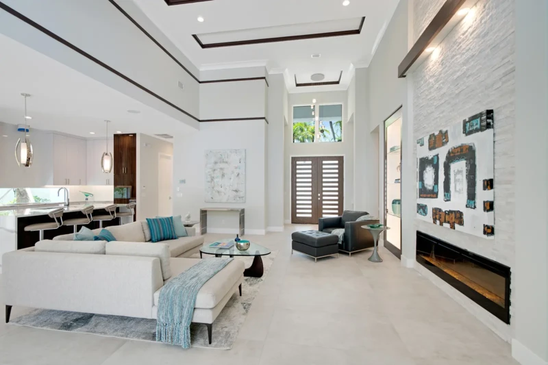Modern luxury great room staging with contemporary fireplace in Sarasota spec home