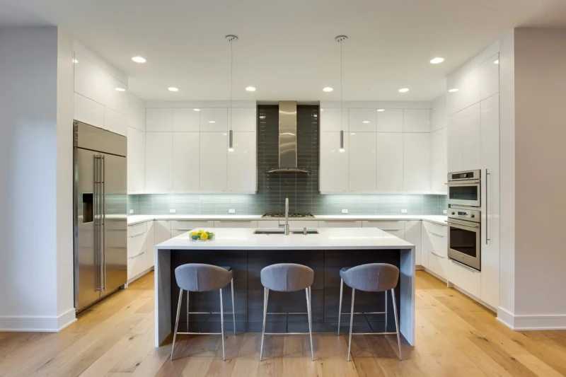 Modern luxury kitchen staging with white cabinetry and oversized waterfall island