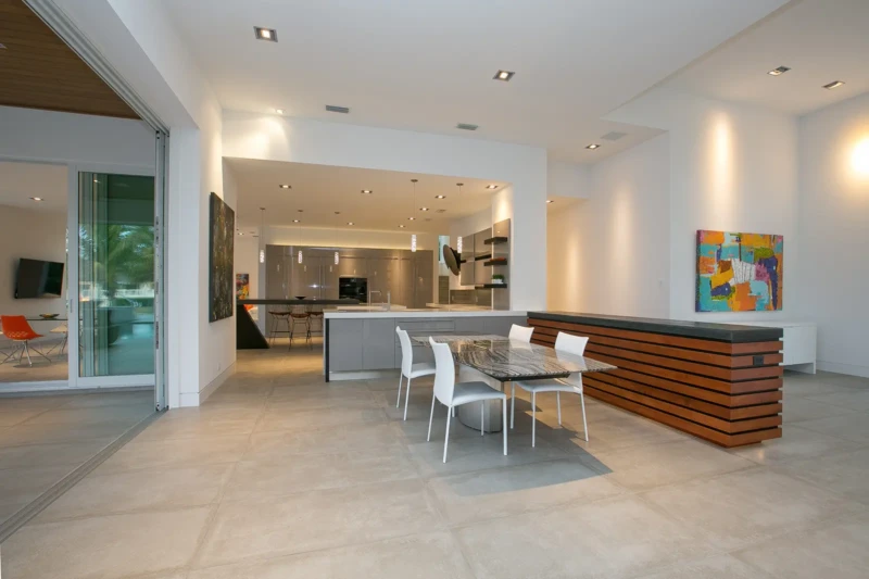 Modern open-concept kitchen and dining area staging in luxury Bay Isles South waterfront home on Longboat Key