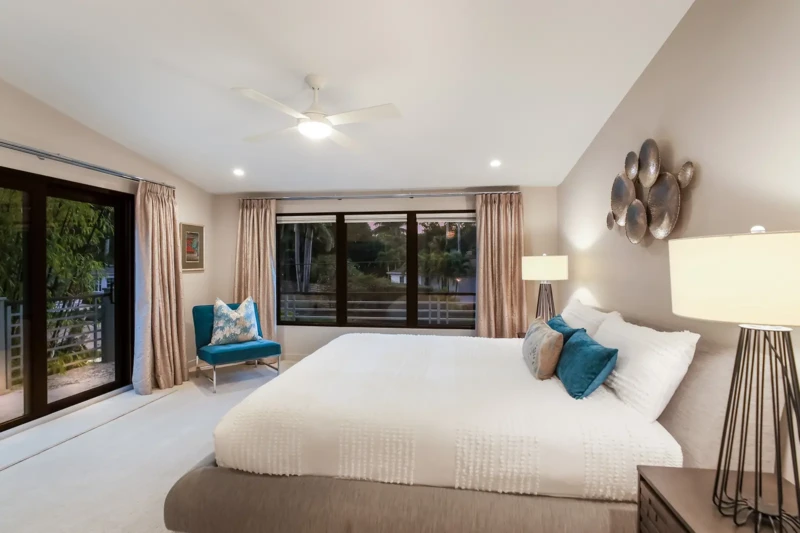 Modern primary bedroom staging with balcony access