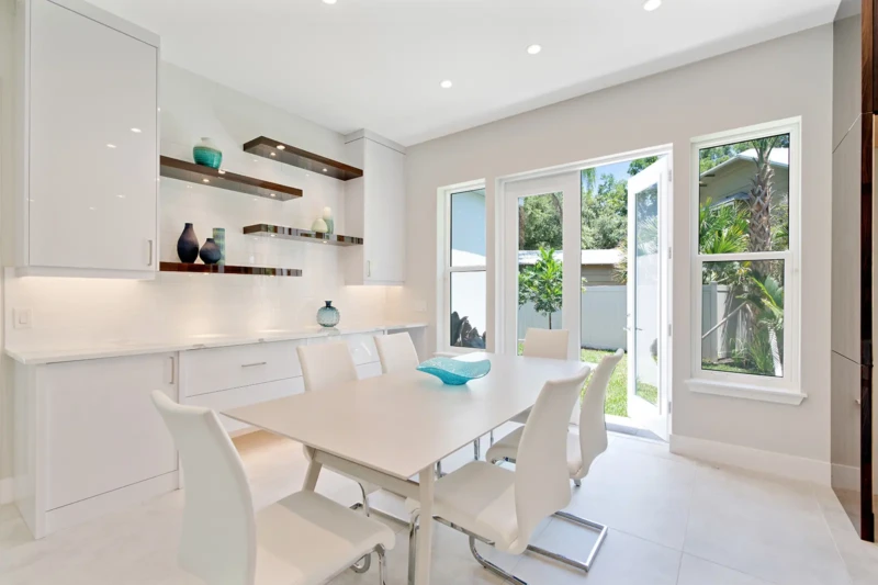 Modern dining area staging with custom shelving in Sarasota luxury spec home