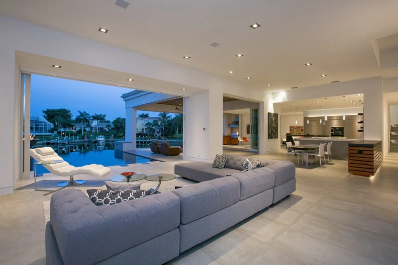 Modern waterfront home staging with open-concept living area and canal views in Bay Isles South on Longboat Key at dusk
