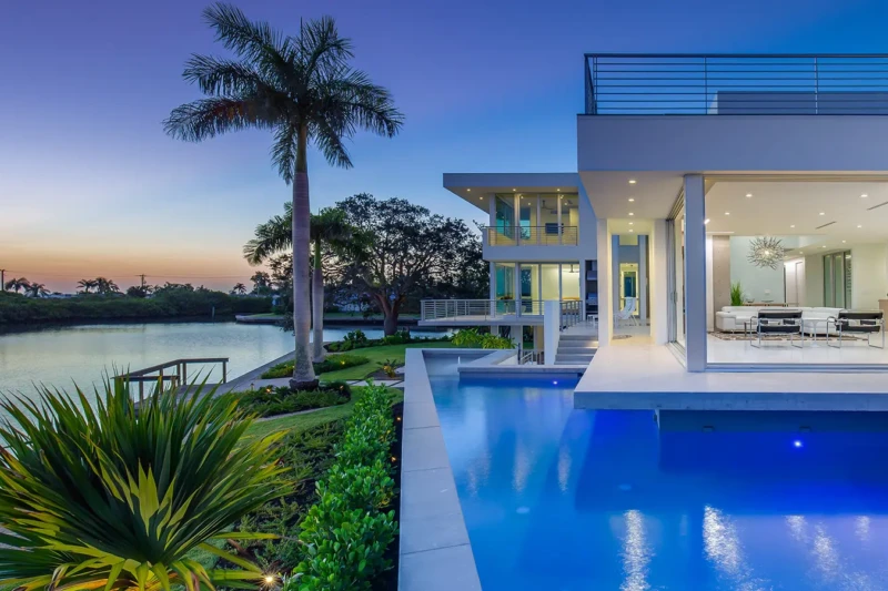 Luxury modern waterfront home staging on Longboat Key with bayfront pool at twilight