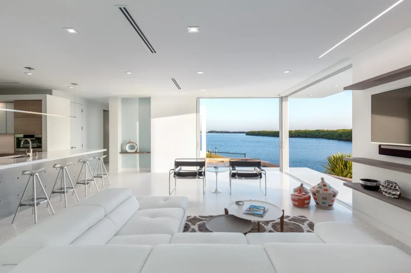 Modern waterfront living room with open-concept design and panoramic bay views on Longboat Key