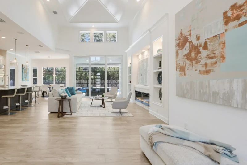 Open concept coastal contemporary living space with vaulted ceilings in West of Trail Sarasota home