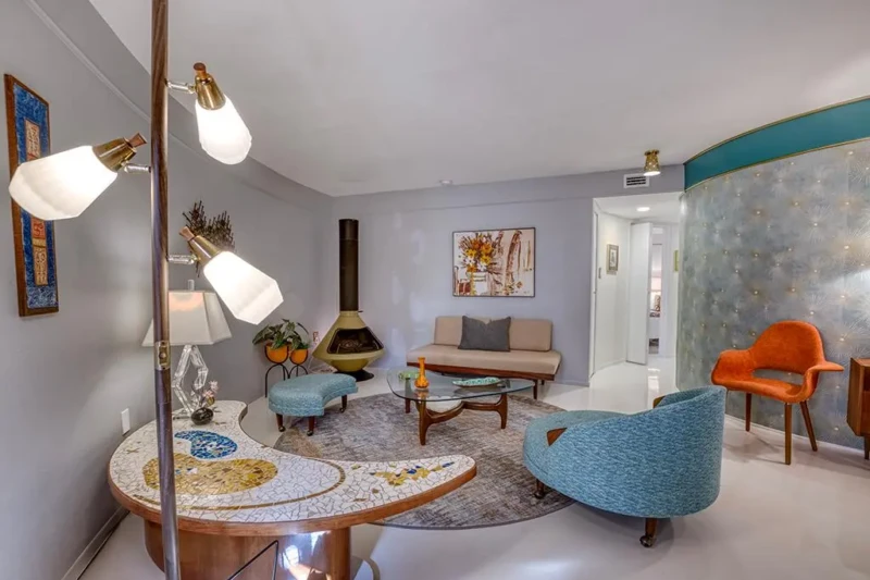Retro mid-century lounge staging with curved walls and vintage modern furniture