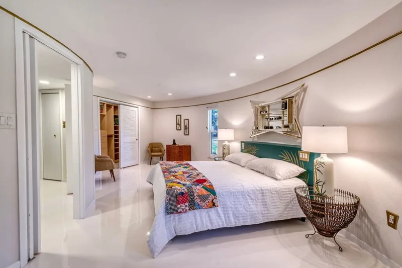 Curved mid-century modern bedroom staging inside Sarasota Round House