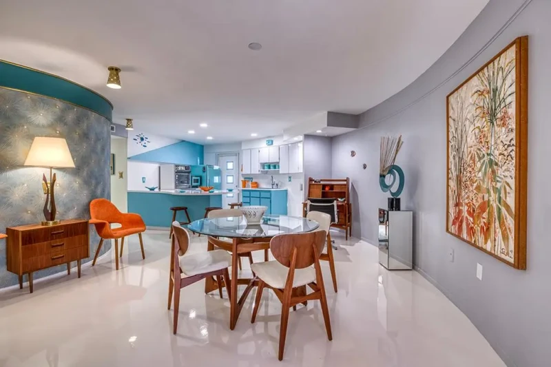 Mid-century modern dining and kitchen staging inside Sarasota Round House