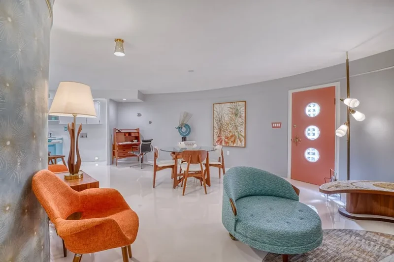 Mid-century modern living and dining space staged inside Sarasota Round House