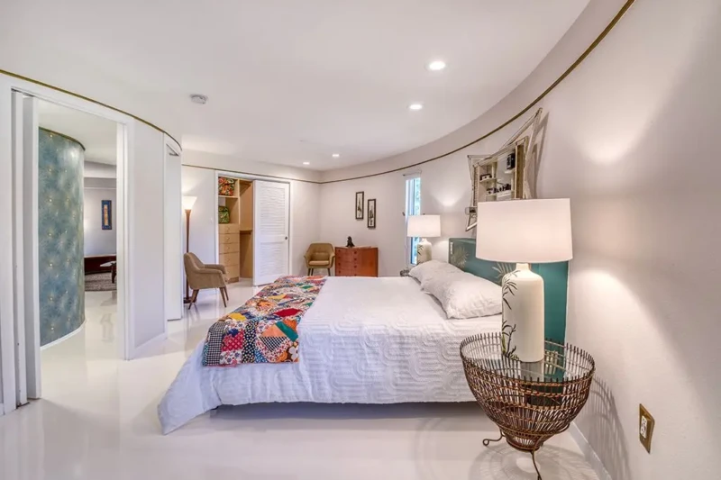 Curved primary bedroom with retro decor in Sarasota Round House