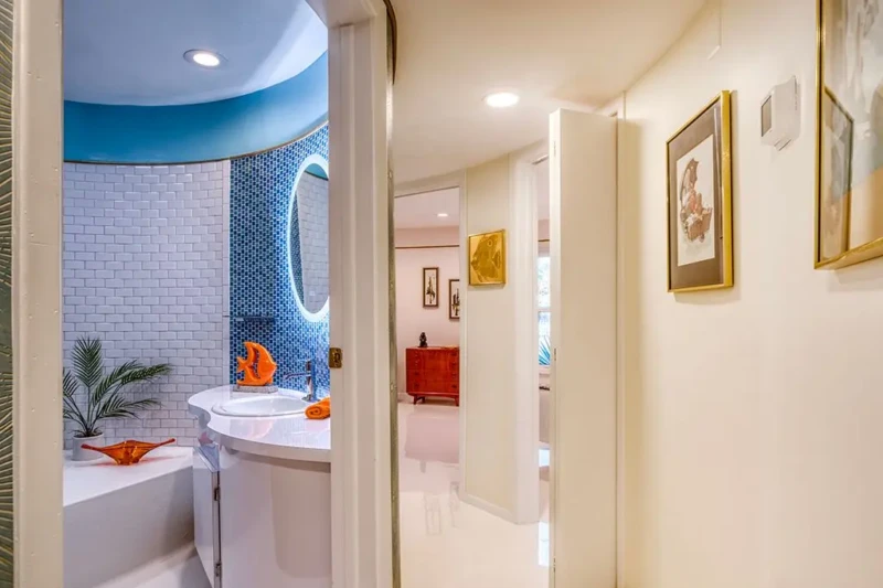 Retro curved bathroom and hallway inside Sarasota Round House home