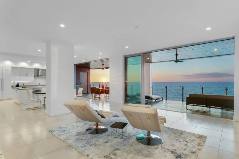 Waterfront condo staging on Siesta Key featuring panoramic Gulf sunset views, luxury indoor-outdoor living, and contemporary coastal interiors